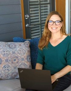 Arista Witty on her patio with a laptop